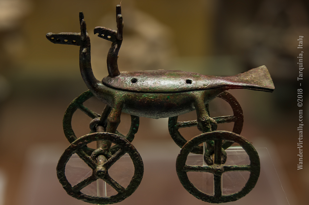 A miniature bronze trolley with four wheels, shaped like a double bird with a horned head: an incense burner used for religious activities. 9th-8th century BCE, Villanovan, from the Necropoli delle Arcatelle. National Etruscan Museum - Tarquinia, Italy.