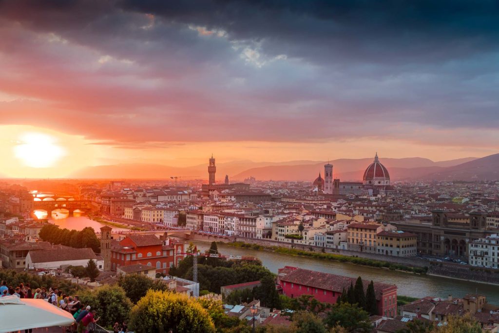 The Florence skyline, viewed from Piazzale Michelangelo, made even more beautiful by a glowing sunset. Photo by Heidi Kaden on Unsplash.