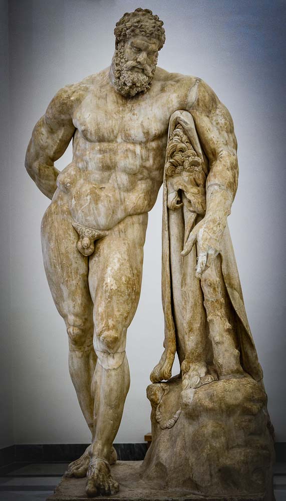 Statue of Hercules at rest leaning against his knotty club on which his lion skin is draped. A 216CE Roman copy of a Greek original from the 4th century BCE, at Naples National Archaeological Museum